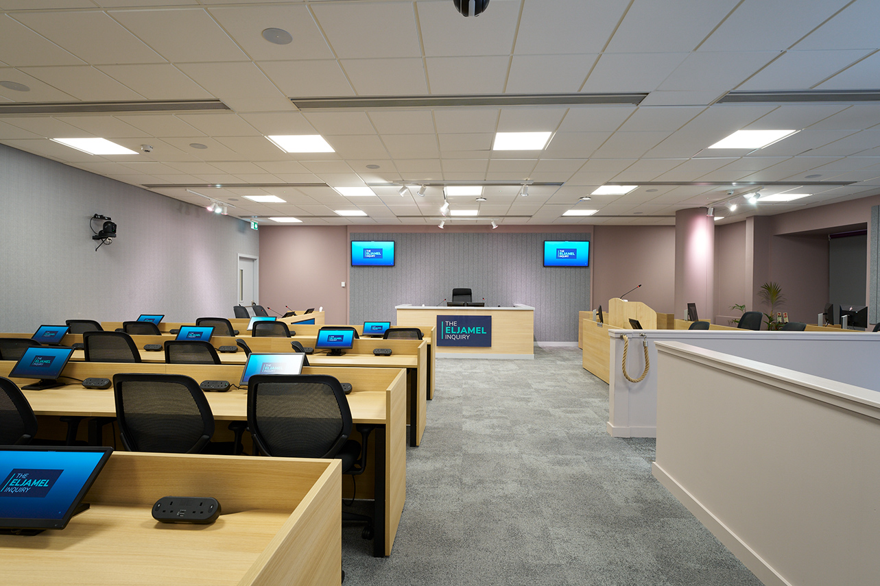 Rows of desks and screens inside the hearing room 