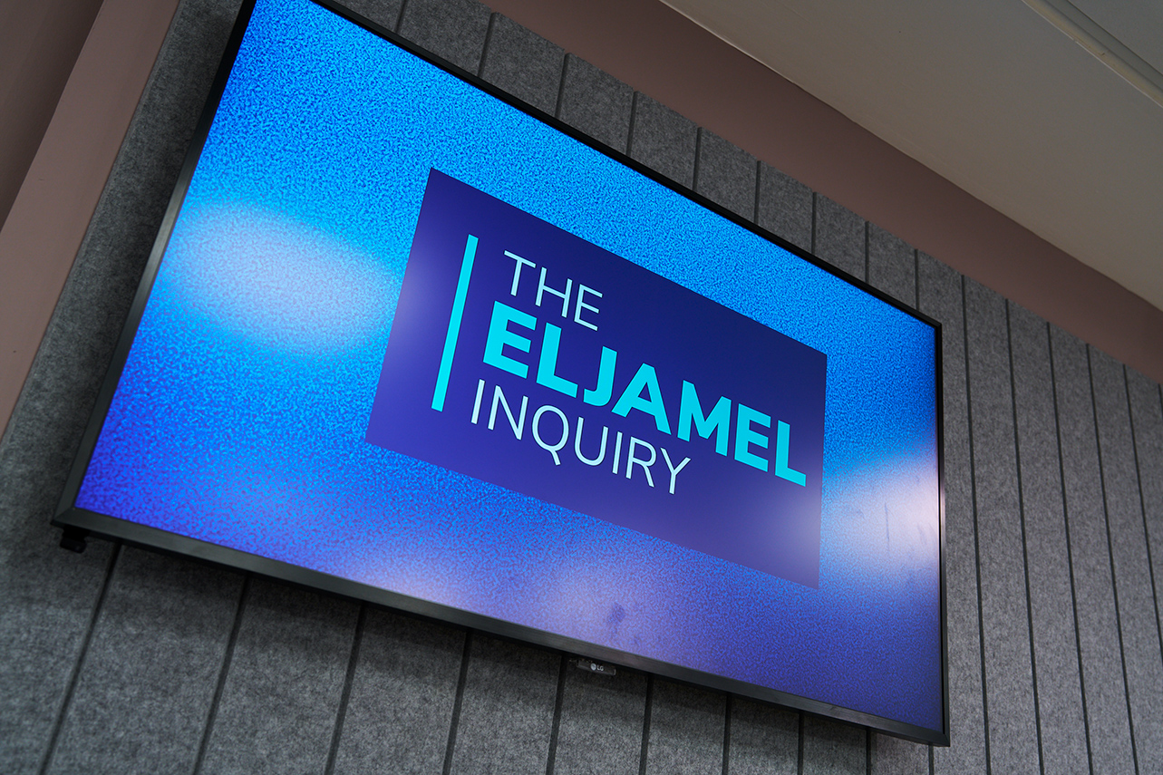 Close up of TV screen displaying Eljamel inquiry logo